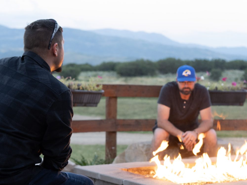 Men talking around the campfire at Big Canyon Ranch